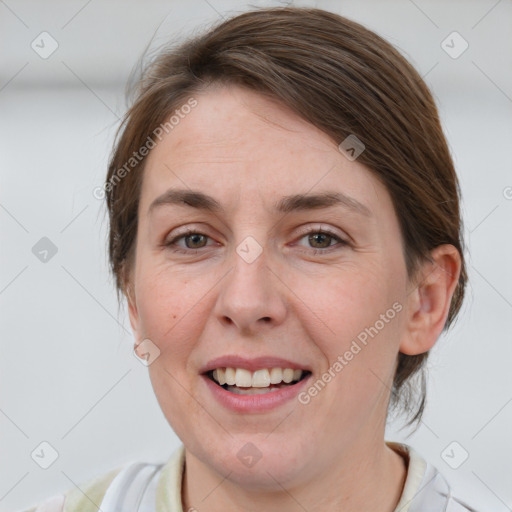 Joyful white adult female with medium  brown hair and grey eyes