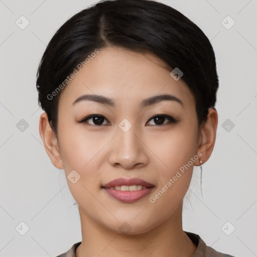 Joyful asian young-adult female with short  black hair and brown eyes