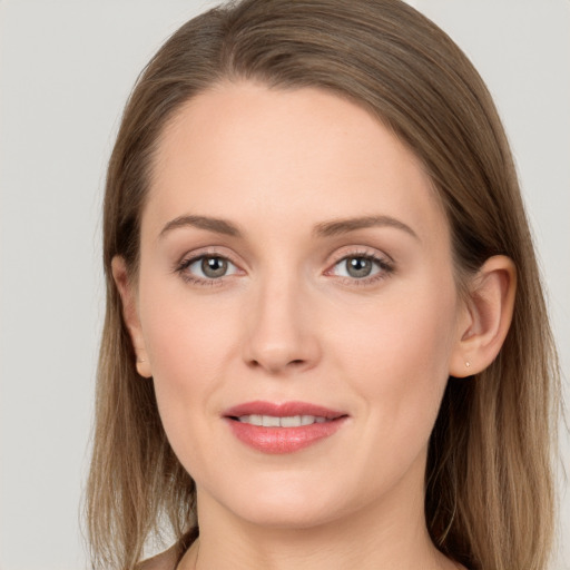 Joyful white young-adult female with long  brown hair and grey eyes