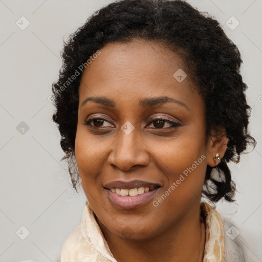 Joyful black young-adult female with long  brown hair and brown eyes