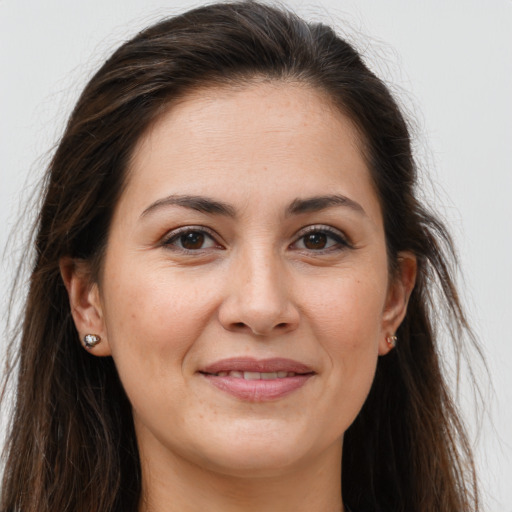 Joyful white young-adult female with long  brown hair and brown eyes