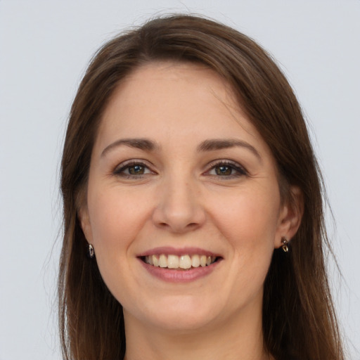 Joyful white young-adult female with long  brown hair and brown eyes