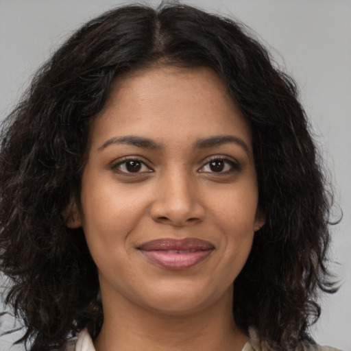 Joyful black young-adult female with medium  brown hair and brown eyes