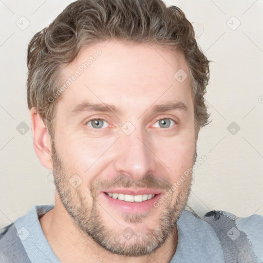 Joyful white young-adult male with short  brown hair and blue eyes