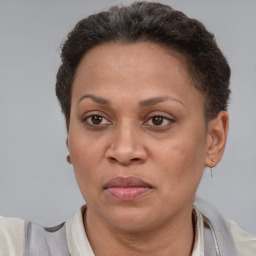 Joyful latino adult female with short  brown hair and brown eyes