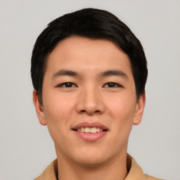 Joyful asian young-adult male with short  black hair and brown eyes