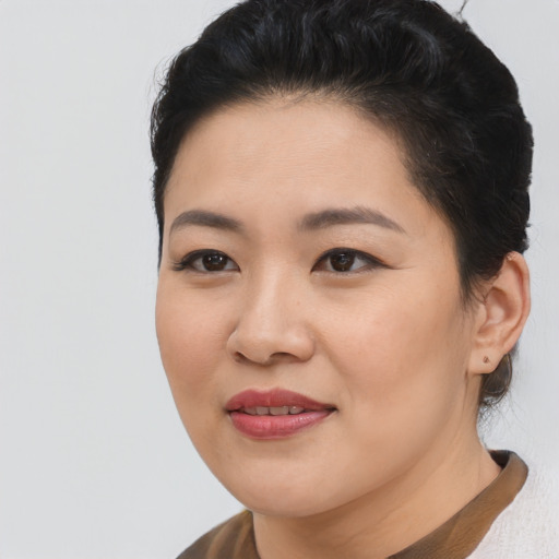 Joyful asian young-adult female with short  black hair and brown eyes