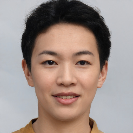 Joyful asian young-adult female with short  black hair and brown eyes