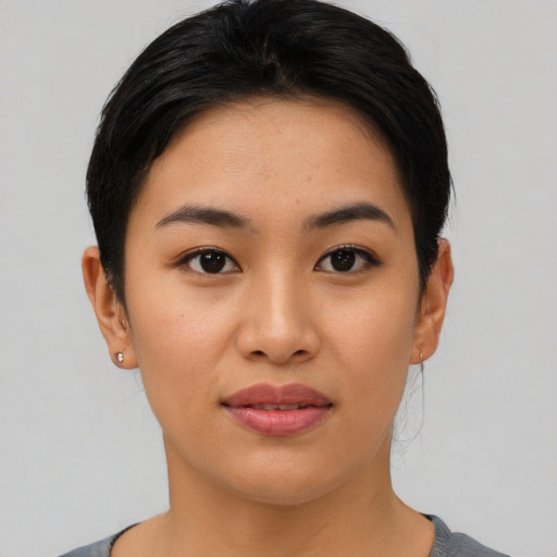 Joyful asian young-adult female with short  black hair and brown eyes