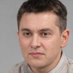 Joyful white adult male with short  brown hair and brown eyes