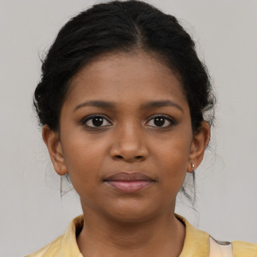 Joyful black young-adult female with medium  brown hair and brown eyes