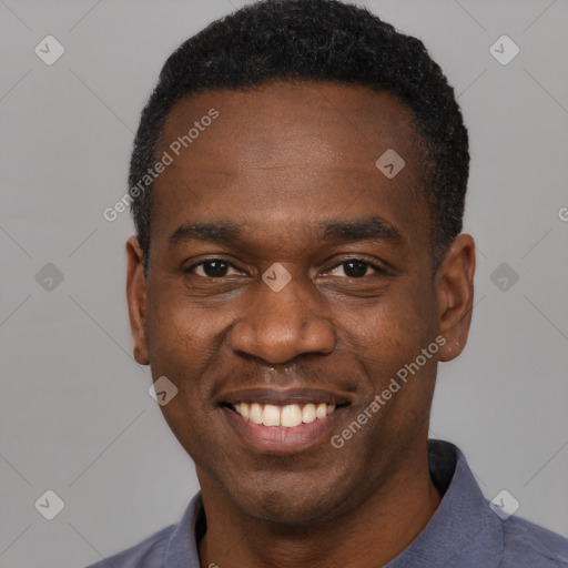 Joyful black young-adult male with short  black hair and brown eyes