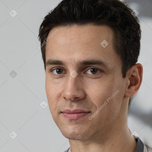 Joyful white adult male with short  black hair and brown eyes