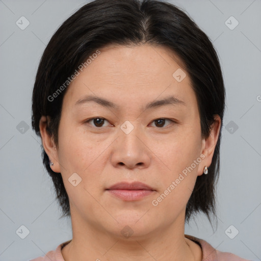 Joyful asian young-adult female with medium  brown hair and brown eyes