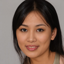 Joyful asian young-adult female with long  brown hair and brown eyes