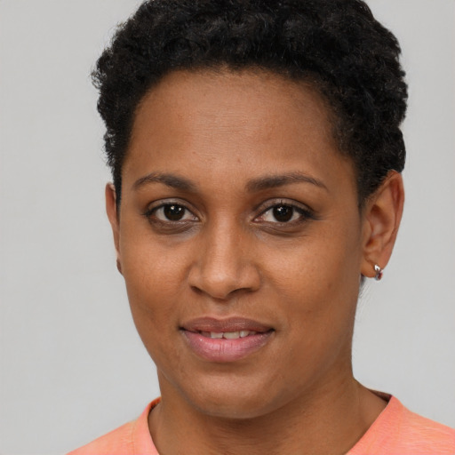 Joyful black young-adult female with short  brown hair and brown eyes