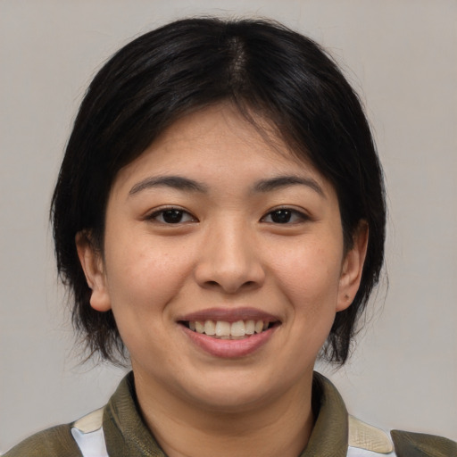Joyful asian young-adult female with medium  brown hair and brown eyes