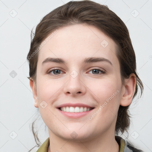 Joyful white young-adult female with medium  brown hair and grey eyes