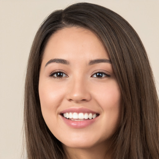 Joyful white young-adult female with long  brown hair and brown eyes