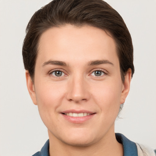 Joyful white young-adult female with short  brown hair and grey eyes