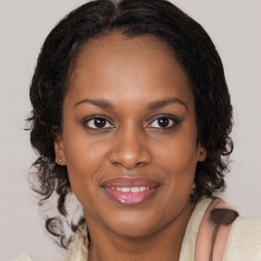Joyful black young-adult female with medium  brown hair and brown eyes