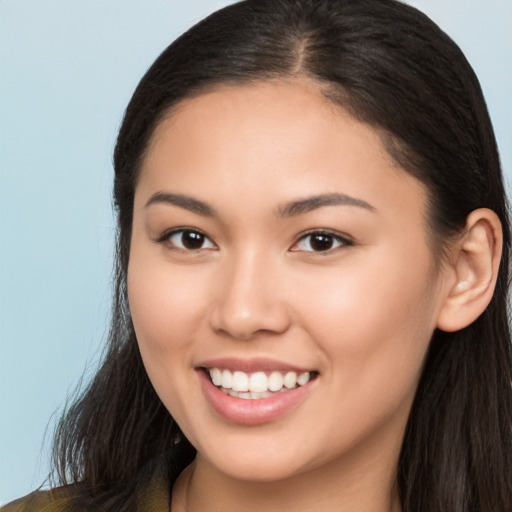 Joyful white young-adult female with long  brown hair and brown eyes