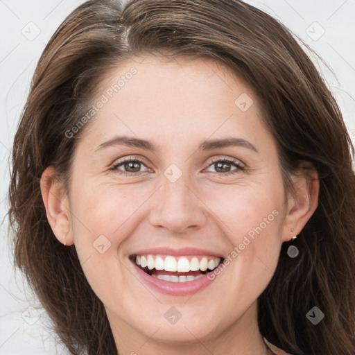 Joyful white young-adult female with long  brown hair and grey eyes