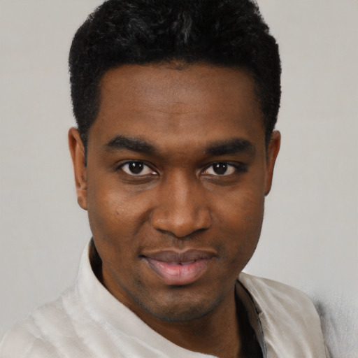 Joyful black young-adult male with short  black hair and brown eyes