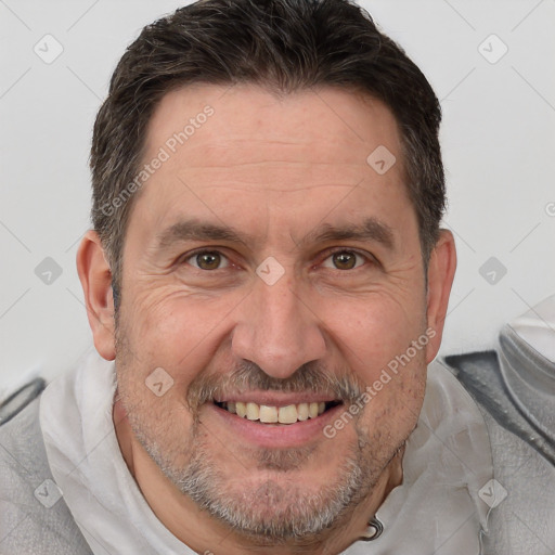 Joyful white adult male with short  brown hair and brown eyes