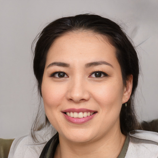 Joyful asian young-adult female with medium  black hair and brown eyes