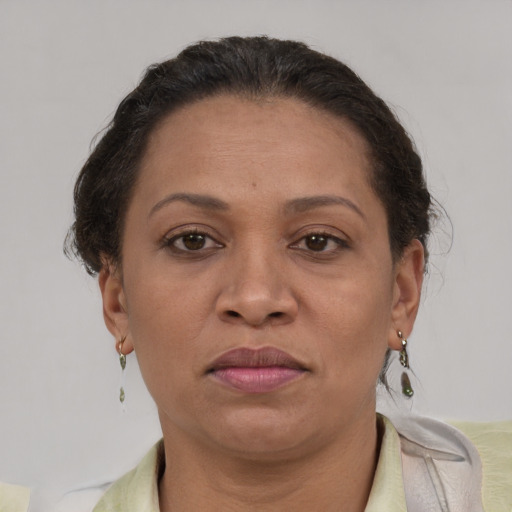 Joyful latino adult female with short  brown hair and brown eyes