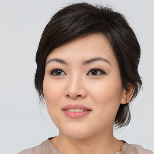 Joyful asian young-adult female with medium  brown hair and brown eyes
