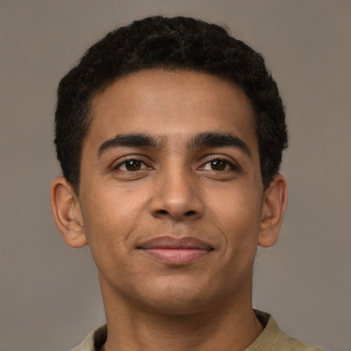 Joyful latino young-adult male with short  brown hair and brown eyes