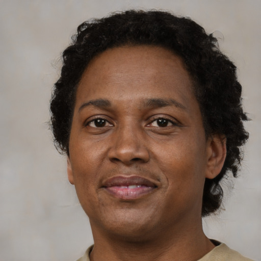Joyful black adult female with short  brown hair and brown eyes