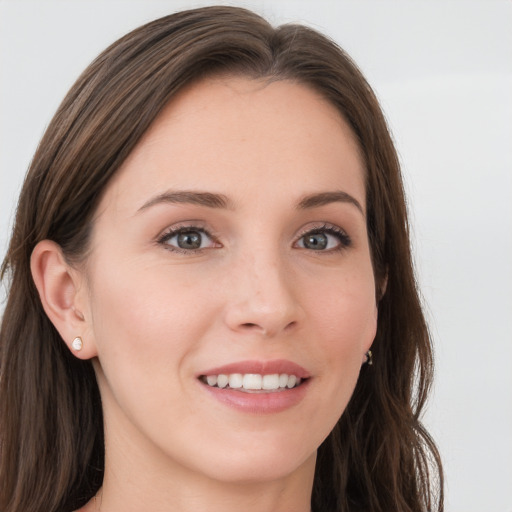 Joyful white young-adult female with long  brown hair and grey eyes