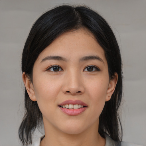 Joyful asian young-adult female with medium  brown hair and brown eyes