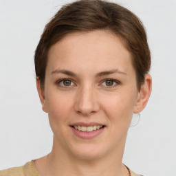 Joyful white young-adult female with short  brown hair and grey eyes