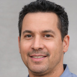 Joyful white adult male with short  brown hair and brown eyes