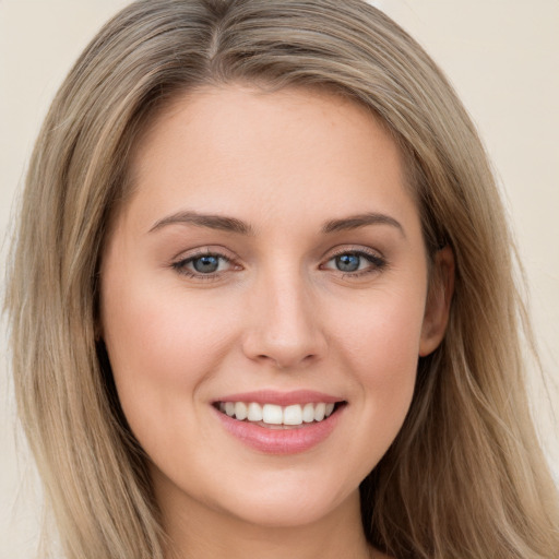 Joyful white young-adult female with long  brown hair and green eyes