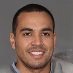 Joyful latino young-adult male with short  brown hair and brown eyes