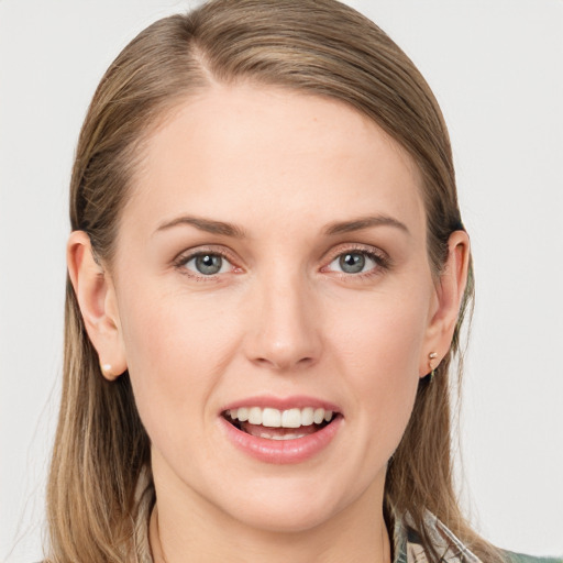 Joyful white young-adult female with long  brown hair and blue eyes