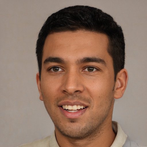 Joyful white young-adult male with short  black hair and brown eyes