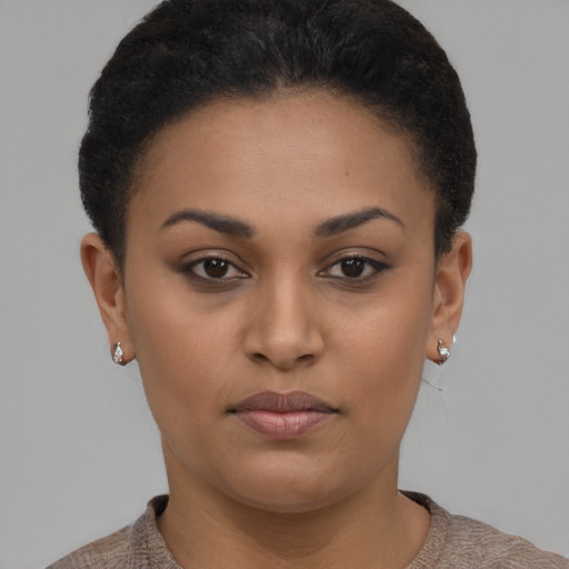Joyful black young-adult female with short  brown hair and brown eyes