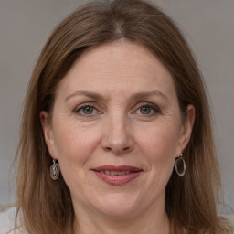 Joyful white adult female with medium  brown hair and grey eyes