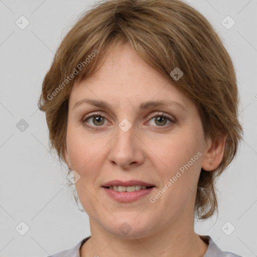 Joyful white adult female with medium  brown hair and grey eyes