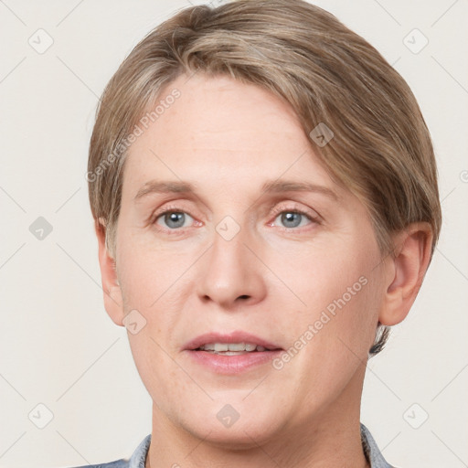 Joyful white adult female with short  brown hair and grey eyes