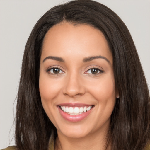 Joyful white young-adult female with long  brown hair and brown eyes