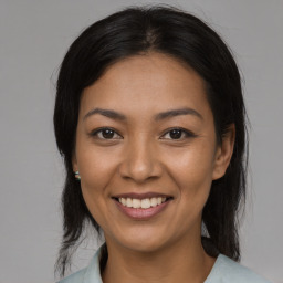 Joyful asian young-adult female with medium  brown hair and brown eyes