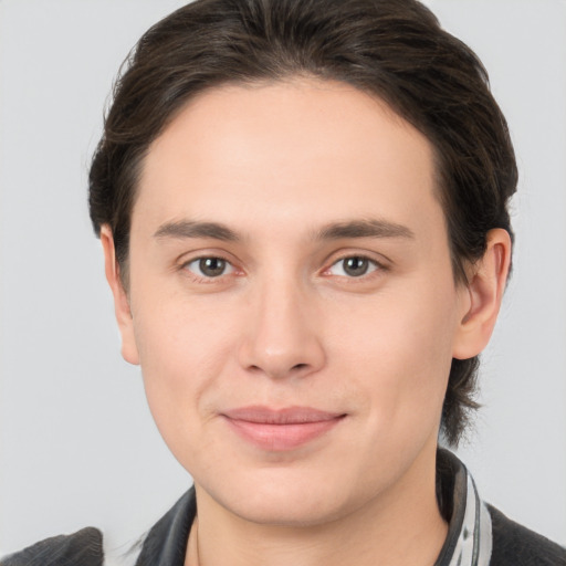 Joyful white young-adult male with medium  brown hair and brown eyes