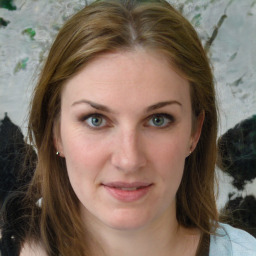 Joyful white young-adult female with long  brown hair and green eyes